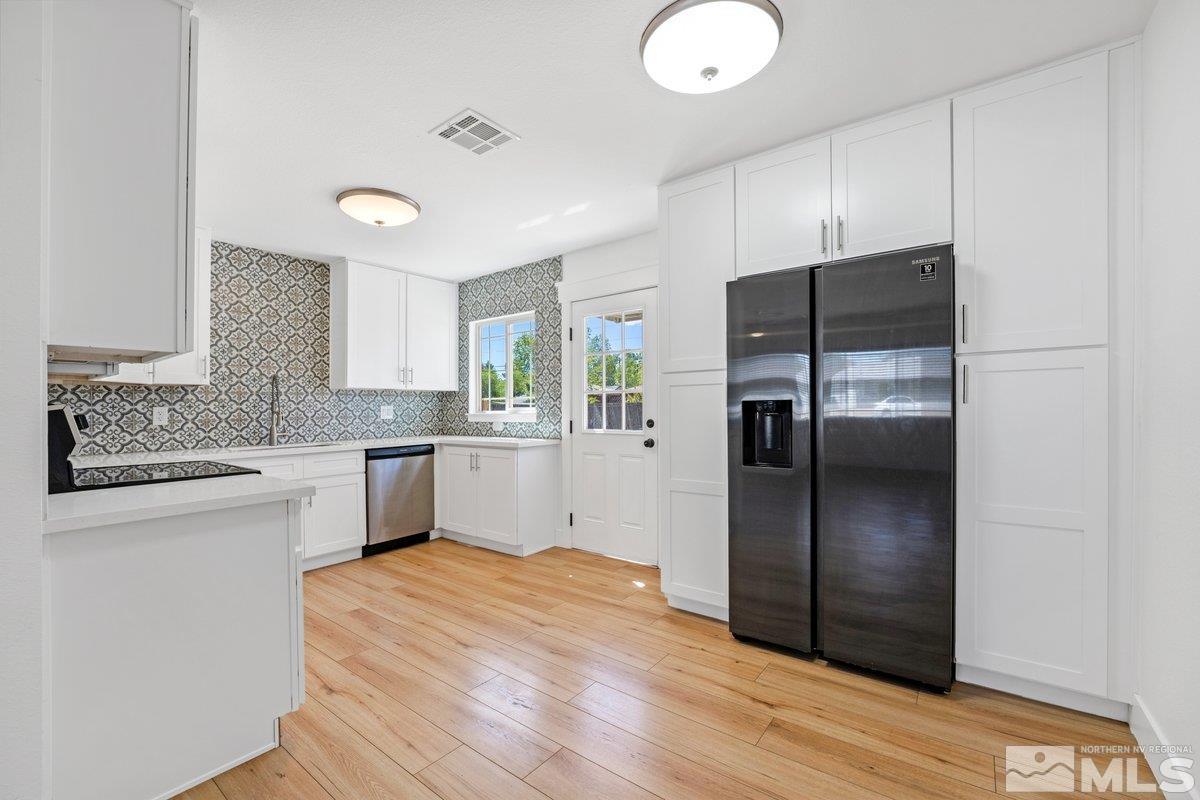 441 I Street Sparks, NV 89431 - Photo 3 of 16 a kitchen with granite countertop stainless steel appliances a refrigerator cabinets and wooden floor