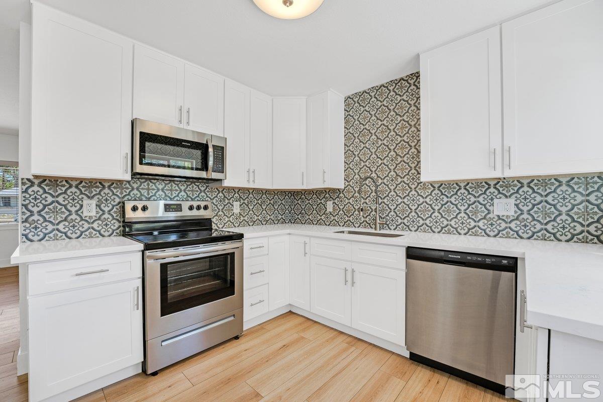 441 I Street Sparks, NV 89431 - Photo 5 of 16 a kitchen with cabinets appliances and wooden floor