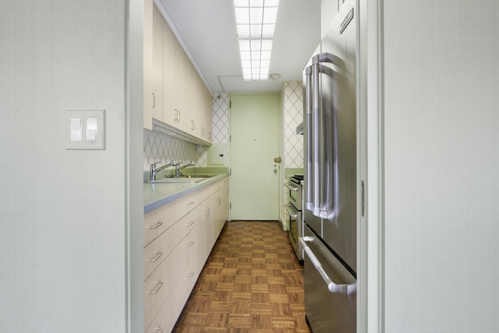180 Beacon Street, Unit 6A Boston, MA 02116 - Photo 10 of 26 a bathroom with a granite countertop sink and washing machine