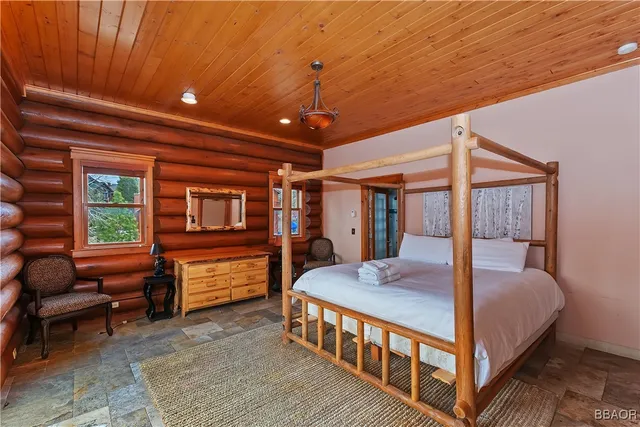 a bedroom with a bed next to a window