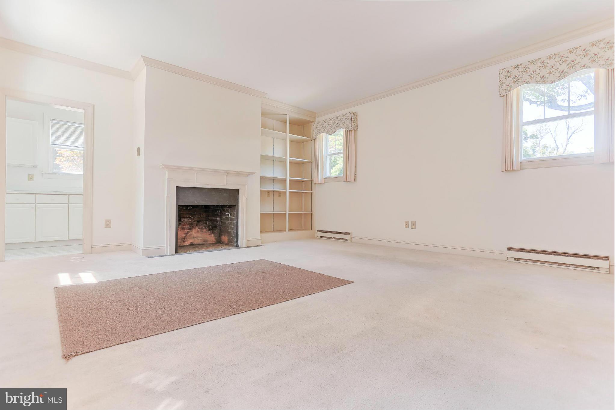 14611 Water Company Road Cascade, MD 21719 - Photo 12 of 30 an empty room with windows and fireplace