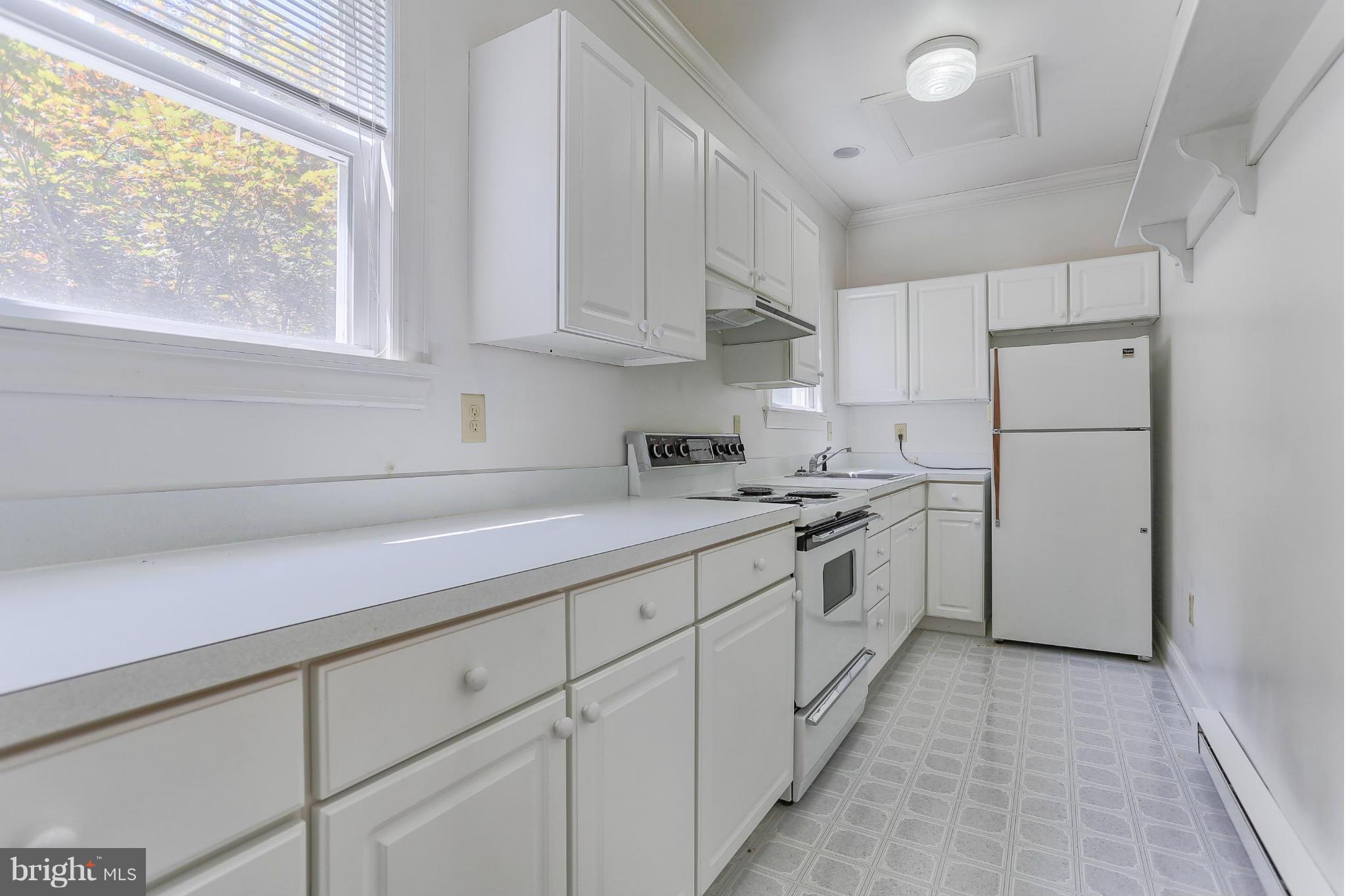 14611 Water Company Road Cascade, MD 21719 - Photo 13 of 30 a kitchen with white cabinets and white appliances