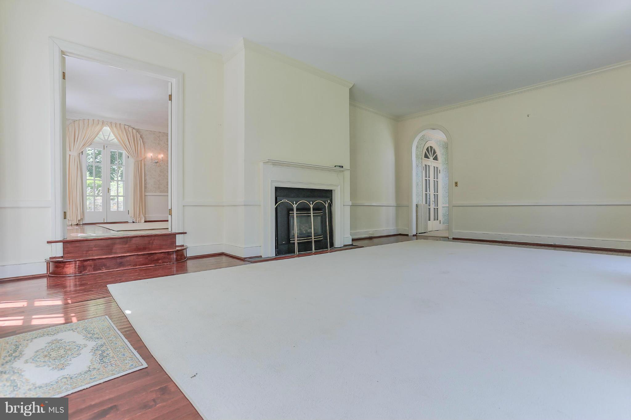 14611 Water Company Road Cascade, MD 21719 - Photo 18 of 30 an empty room with fireplace and windows