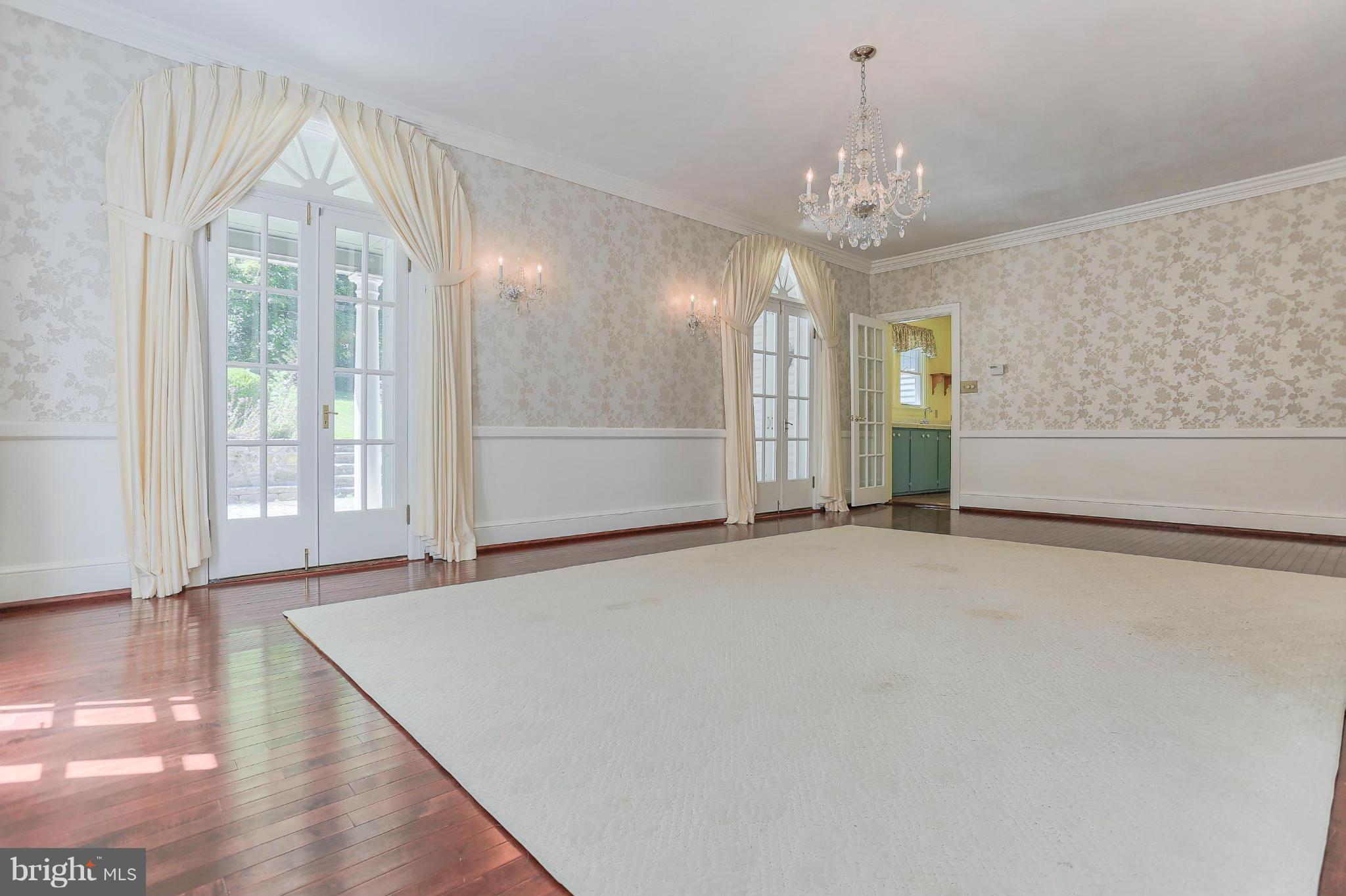 14611 Water Company Road Cascade, MD 21719 - Photo 19 of 30 a view of an empty room with window and chandelier fan