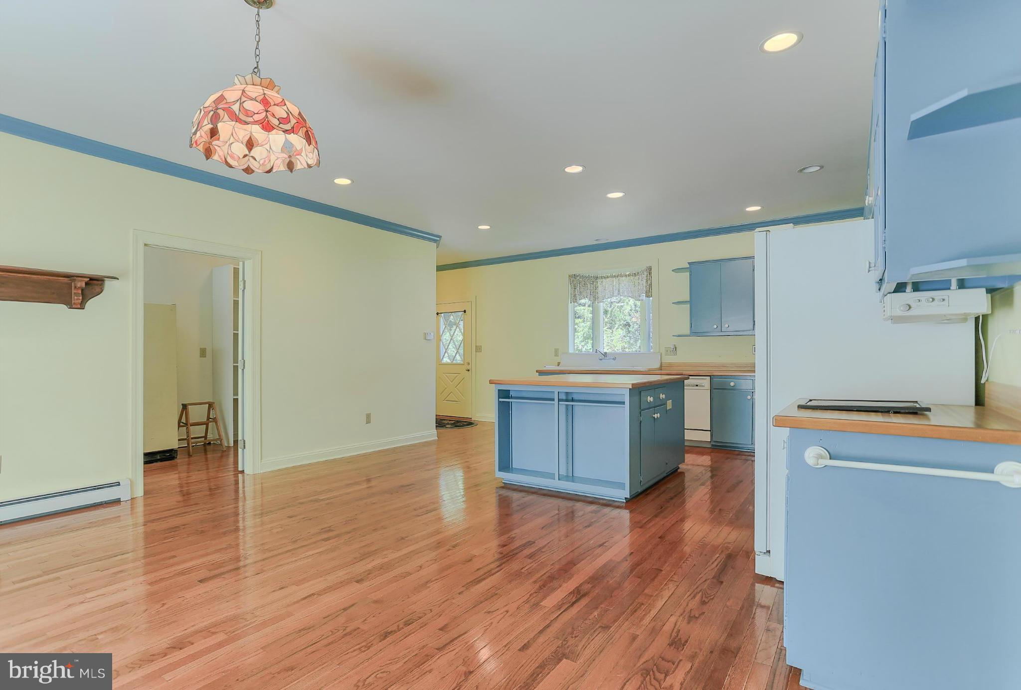 14611 Water Company Road Cascade, MD 21719 - Photo 20 of 30 a kitchen with stainless steel appliances kitchen island wooden cabinets and entryway