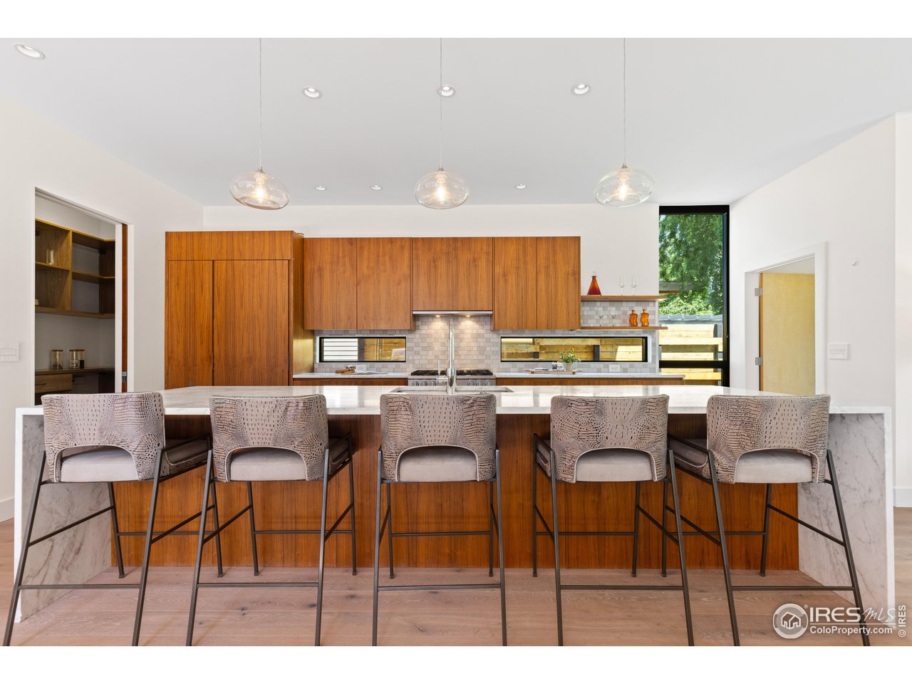 550 Iris Avenue Boulder, CO 80304 - Photo 16 of 40 a kitchen with stainless steel appliances kitchen island granite countertop a table and chairs