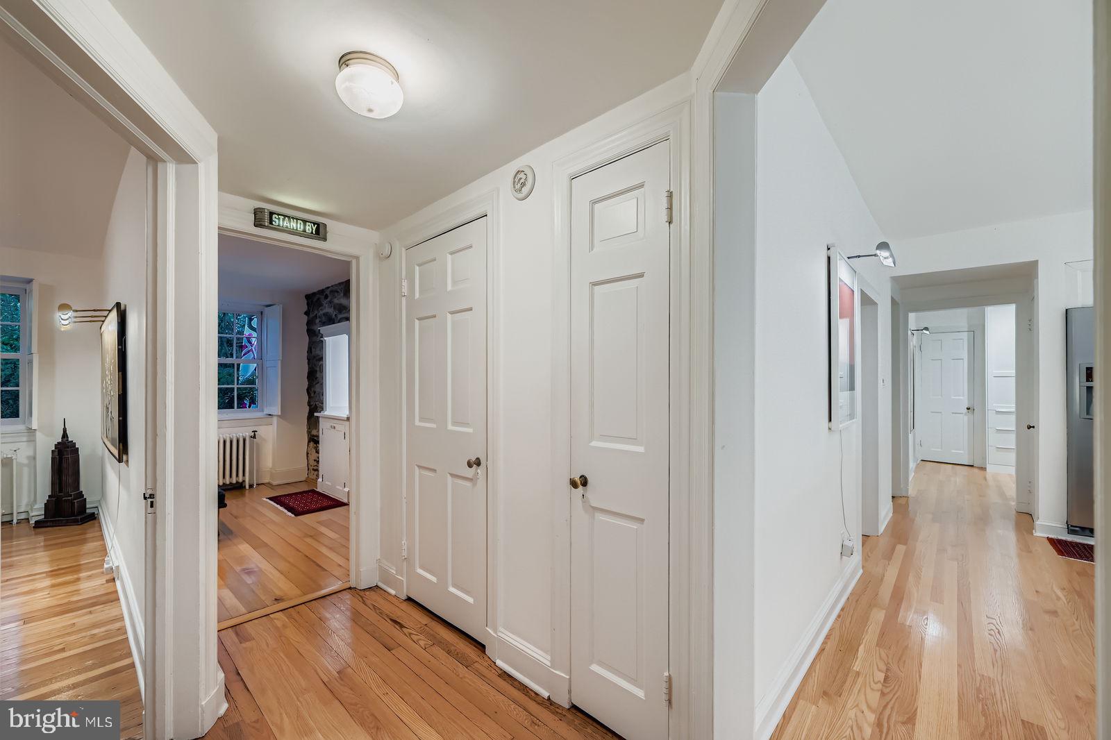 2436 Pickwick Road Baltimore, MD 21207 - Photo 22 of 66 a view of a hallway with wooden floor and staircase