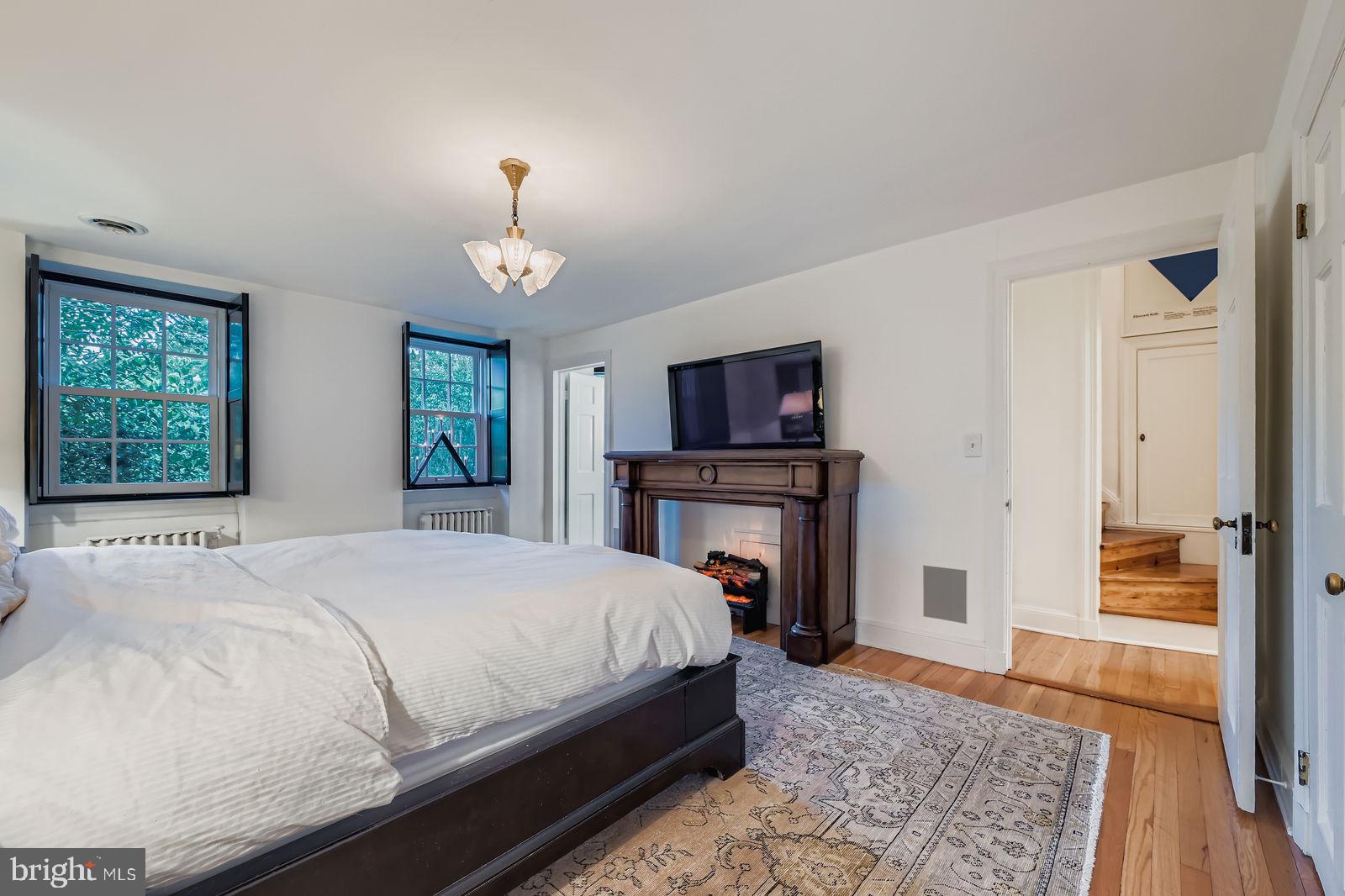 2436 Pickwick Road Baltimore, MD 21207 - Photo 29 of 66 a bedroom with a bed and a fireplace