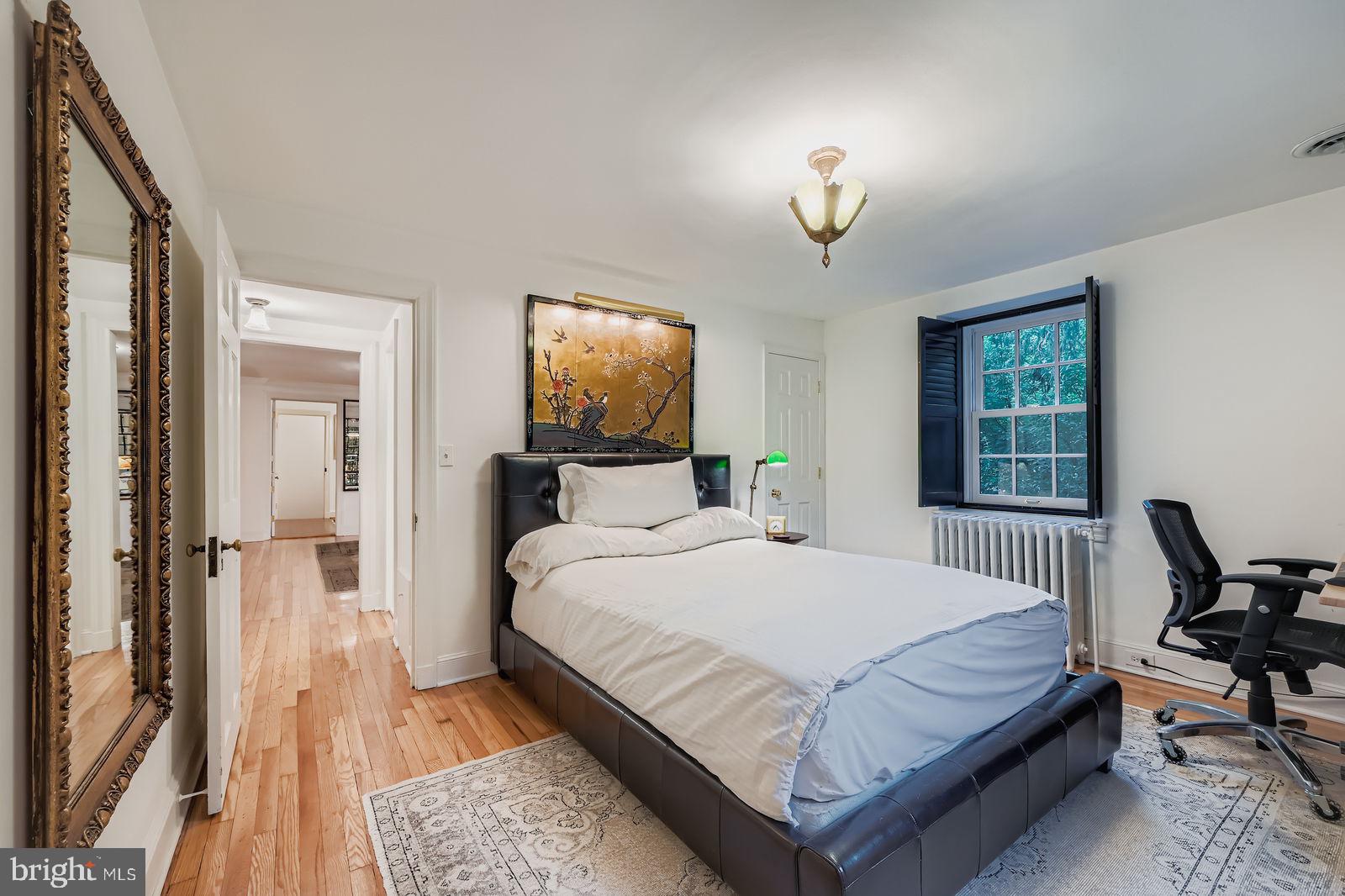 2436 Pickwick Road Baltimore, MD 21207 - Photo 36 of 66 a bedroom with a bed and a chandelier