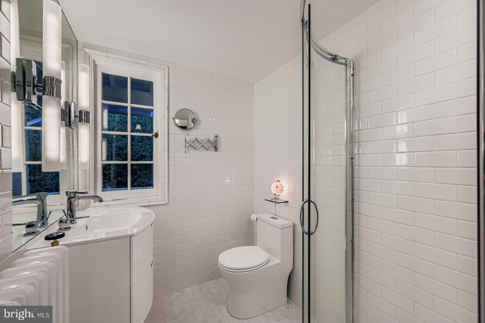 2436 Pickwick Road Baltimore, MD 21207 - Photo 37 of 66 a bathroom with a toilet sink and shower