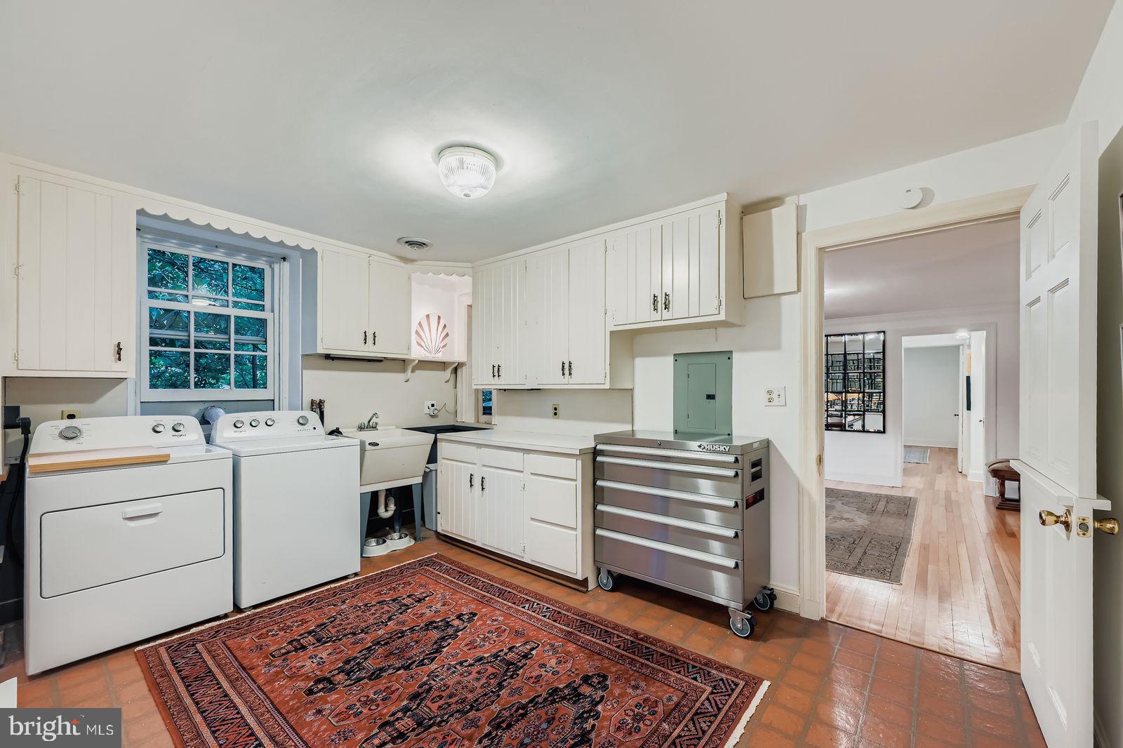 2436 Pickwick Road Baltimore, MD 21207 - Photo 39 of 66 a kitchen with a stove a sink and a refrigerator
