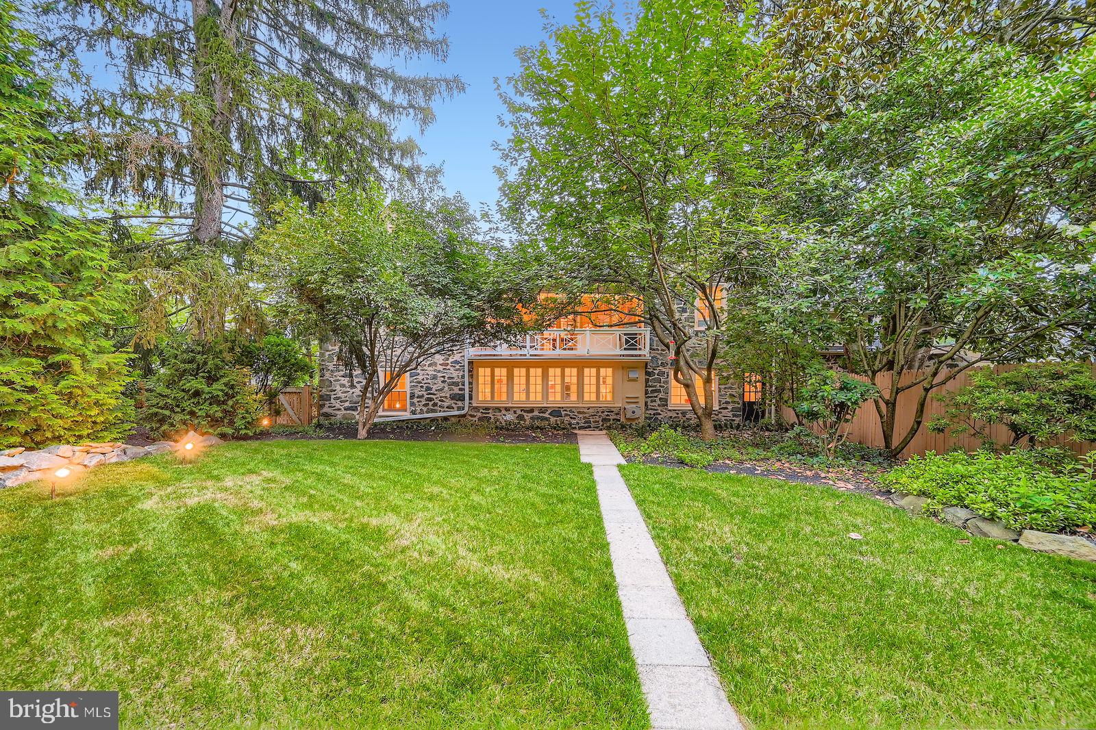 2436 Pickwick Road Baltimore, MD 21207 - Photo 51 of 66 a view of a yard with plants and large trees
