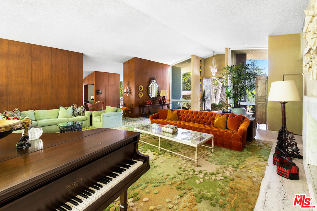1005 Summit Drive Beverly Hills, CA 90210 - Photo 12 of 48 a living room with furniture and a lamp