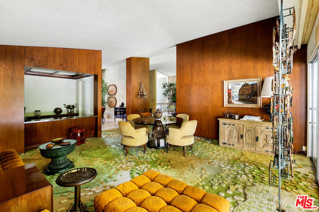 1005 Summit Drive Beverly Hills, CA 90210 - Photo 17 of 48 a living room with furniture and a window