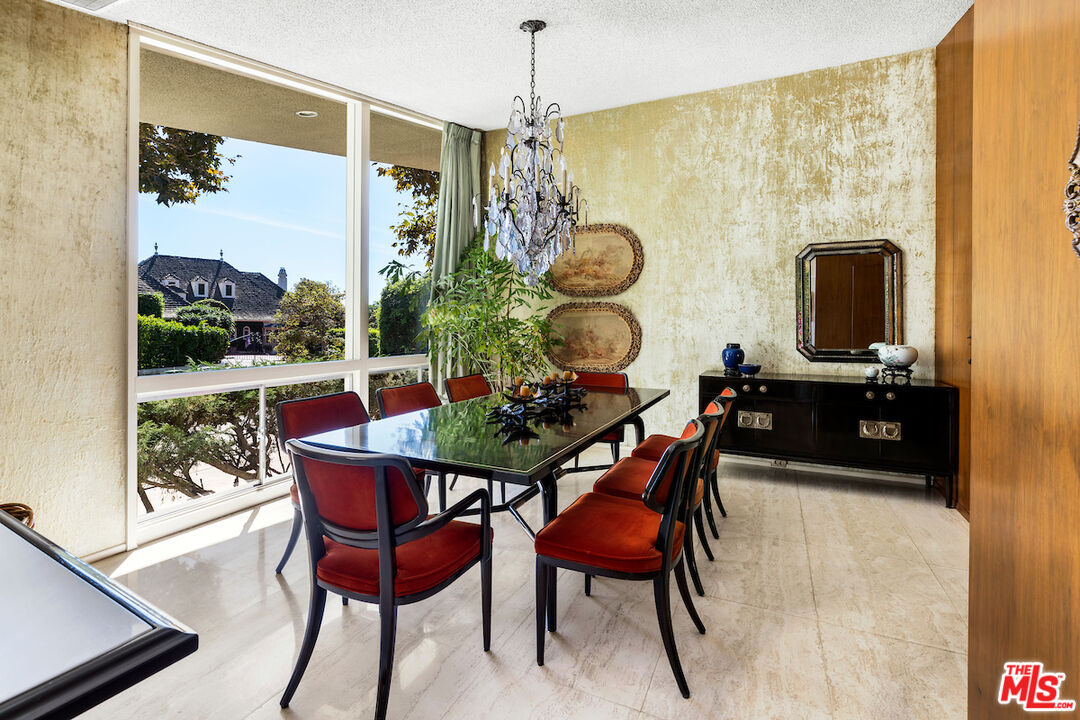 1005 Summit Drive Beverly Hills, CA 90210 - Photo 25 of 48 a dining room with furniture and window