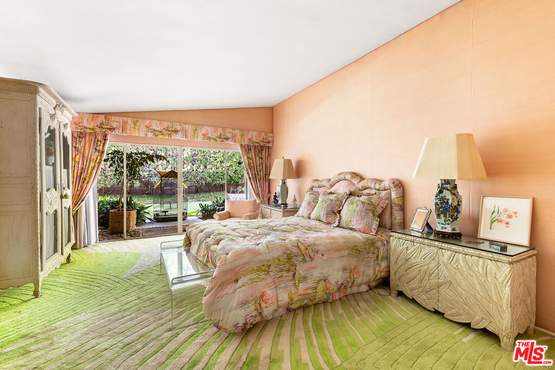 1005 Summit Drive Beverly Hills, CA 90210 - Photo 28 of 48 a bedroom with a bed and a night stand