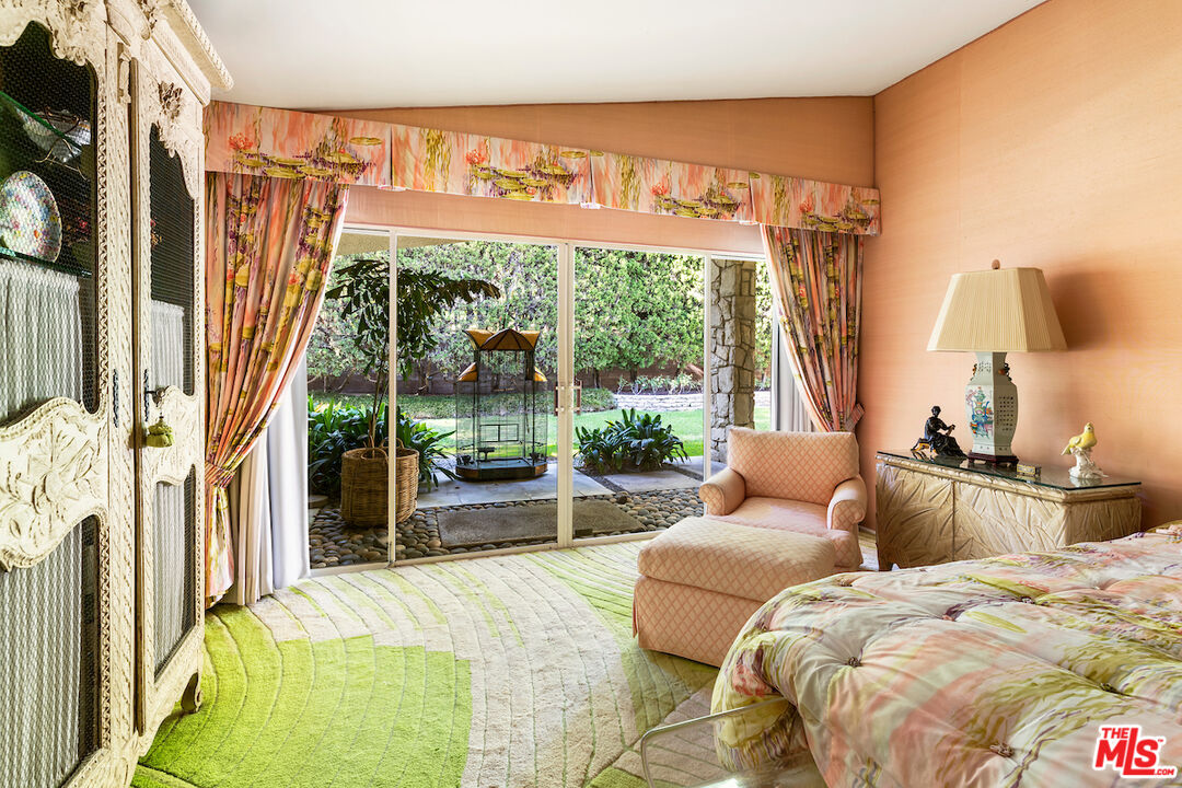 1005 Summit Drive Beverly Hills, CA 90210 - Photo 29 of 48 a bedroom with furniture and a large window