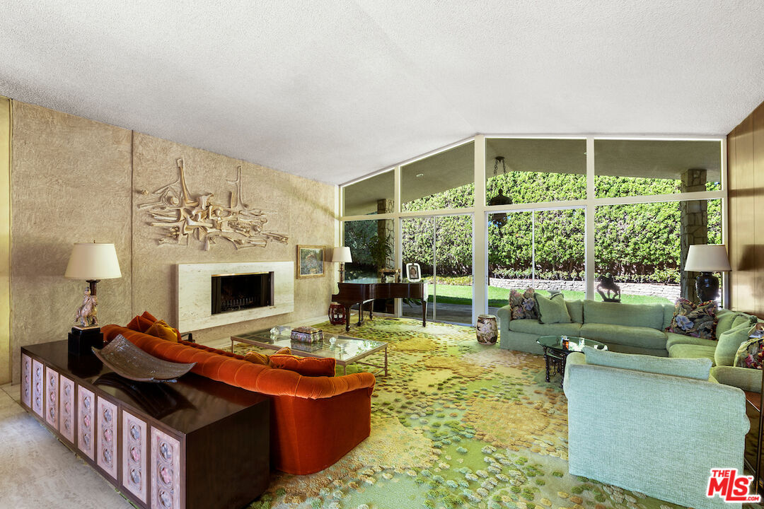 1005 Summit Drive Beverly Hills, CA 90210 - Photo 9 of 48 a living room with furniture large window and a fireplace