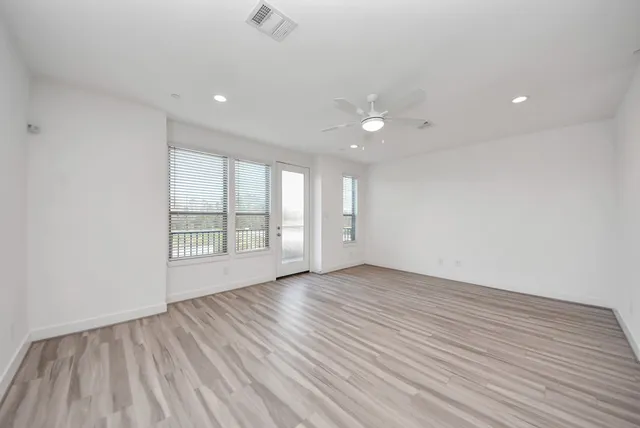 a view of wooden floor and windows in a room