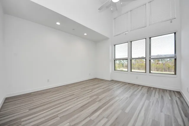 a view of an empty room with wooden floor