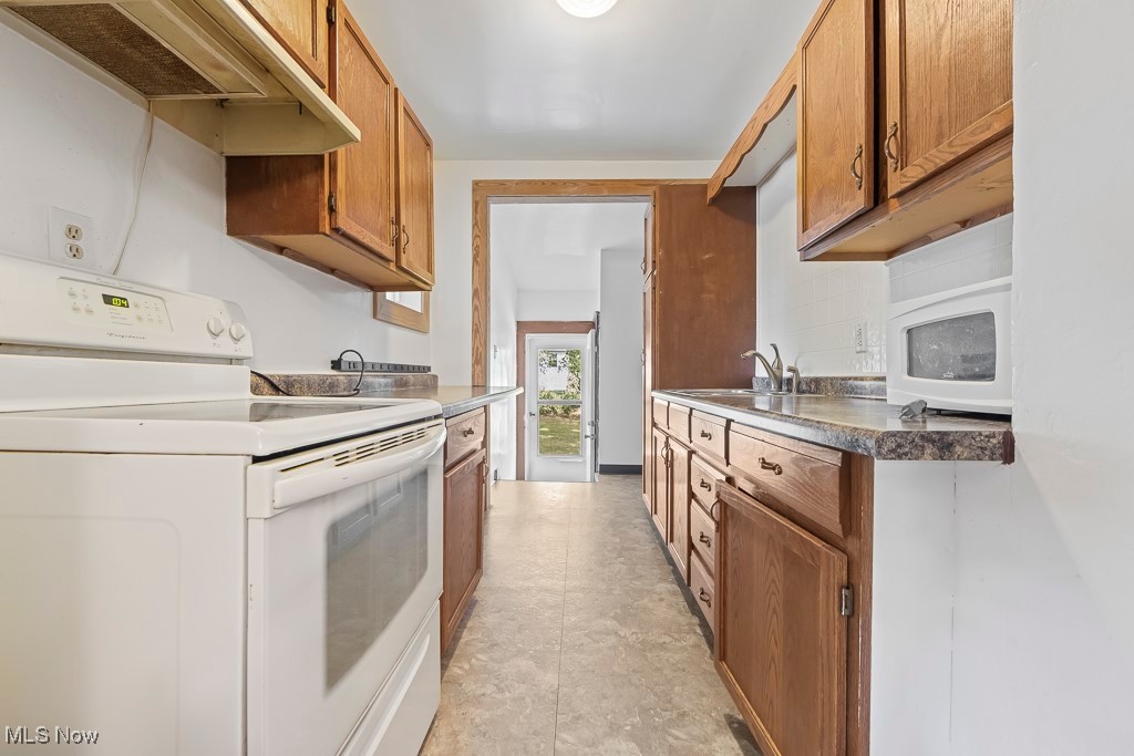 2725 Linwood Road Akron, OH 44312 - Photo 30 of 38 Kitchen featuring white appliances and sink