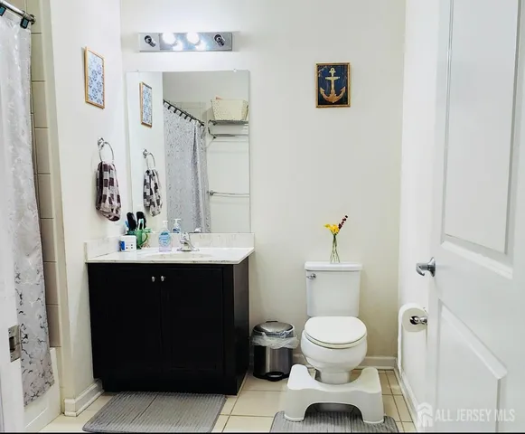 a bathroom with a toilet a sink and mirror