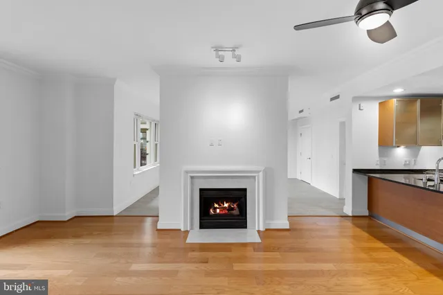 a view of an empty room with a fireplace and a window