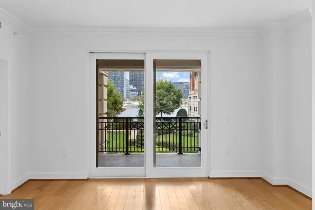 a view of a livingroom with wooden floor and floor to ceiling window