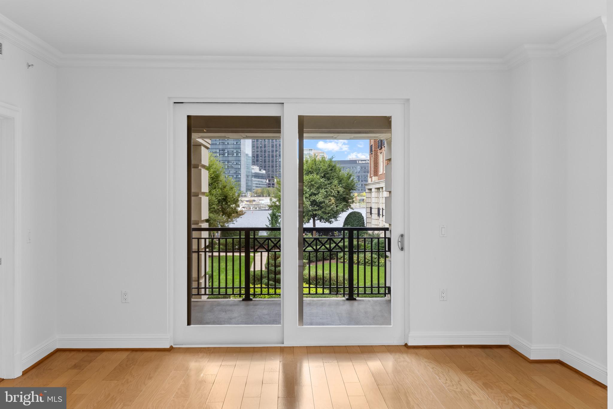801 Key Highway, Unit 242 Baltimore, MD 21230 - Photo 16 of 52 a view of a livingroom with wooden floor and floor to ceiling window