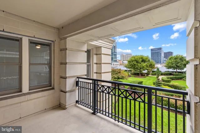 a view of a porch with a floor to ceiling window and potted plants