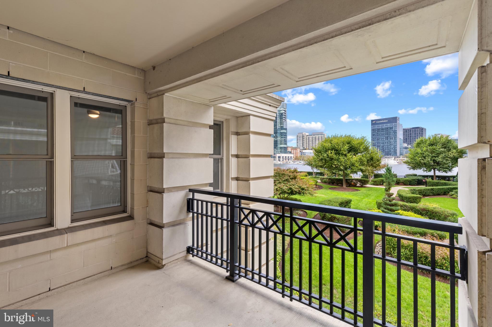 801 Key Highway, Unit 242 Baltimore, MD 21230 - Photo 19 of 52 a view of a porch with a floor to ceiling window and potted plants