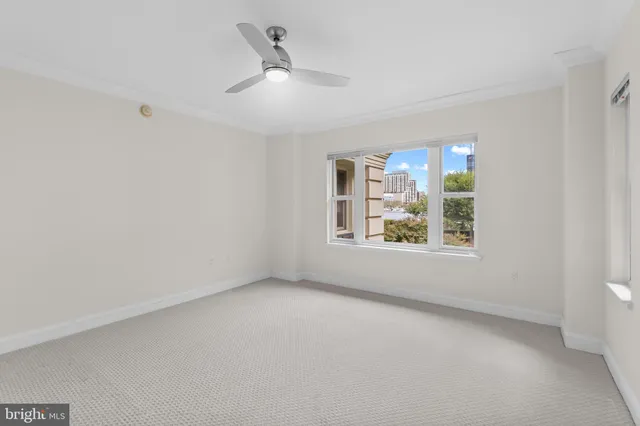 a view of an empty room with a fan