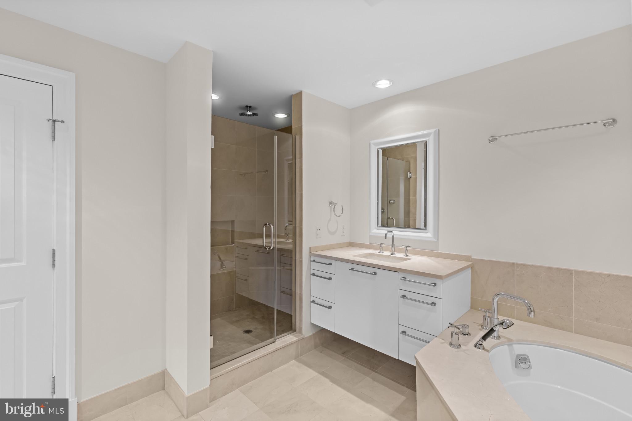 801 Key Highway, Unit 242 Baltimore, MD 21230 - Photo 35 of 52 a bathroom with a double vanity sink mirror and bathtub