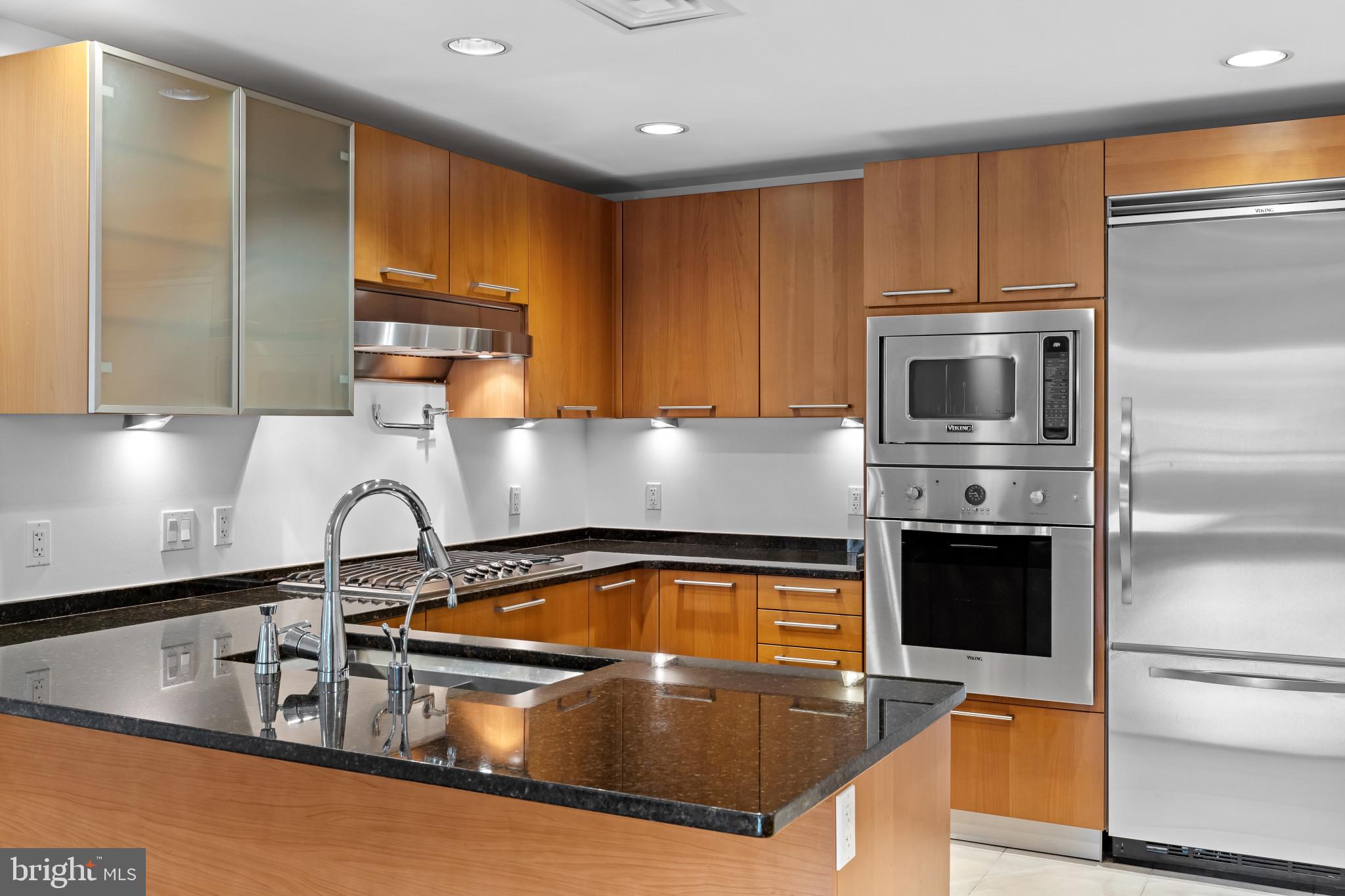 801 Key Highway, Unit 242 Baltimore, MD 21230 - Photo 4 of 52 a kitchen with granite countertop a sink stainless steel appliances and cabinets
