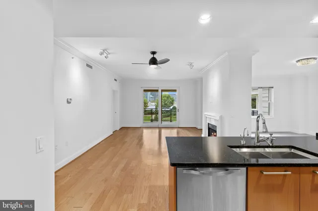a kitchen with a sink a window and cabinets