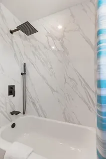 a bedroom with bed and a chandelier