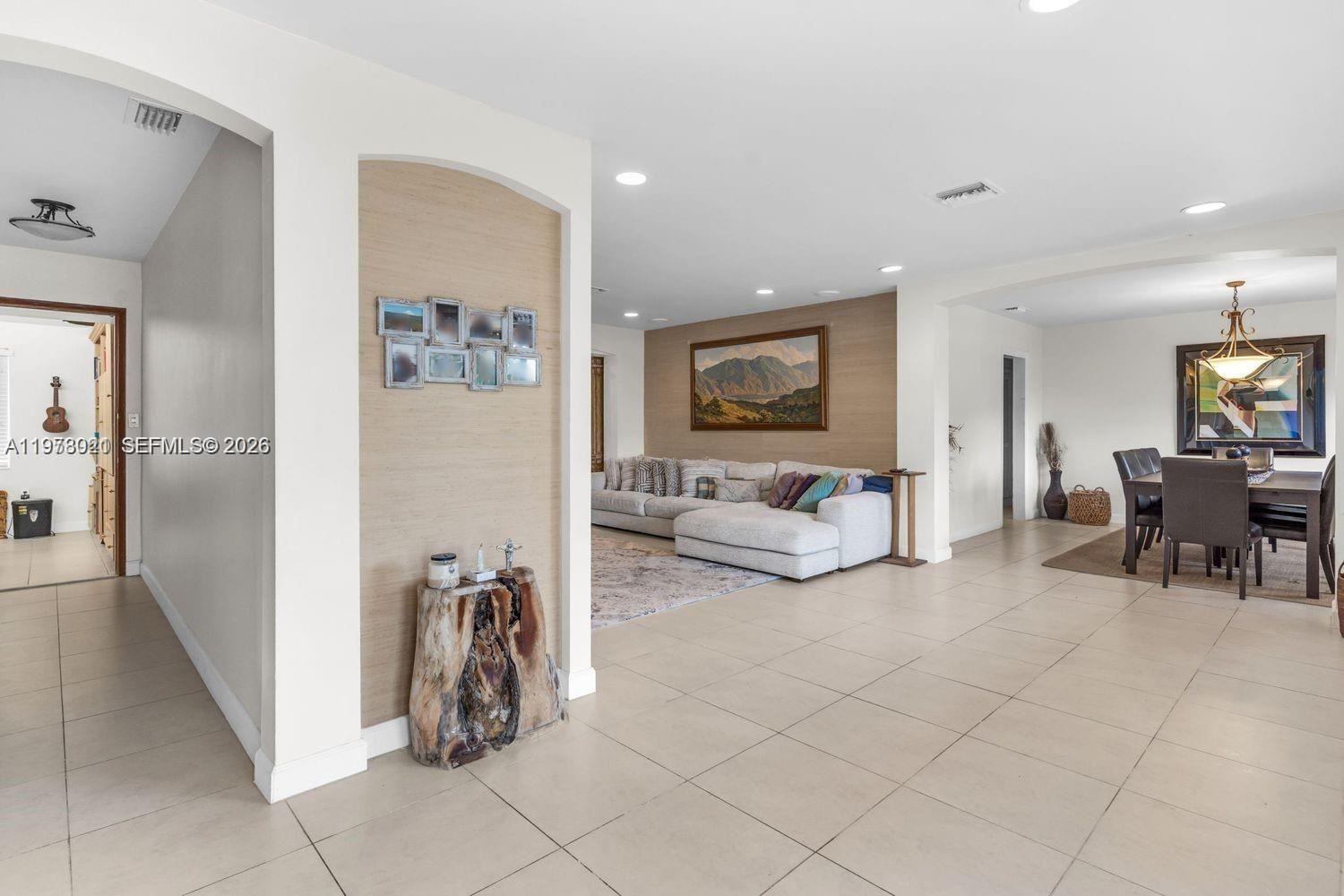 6440 Southwest 129th Terrace Pinecrest, FL 33156 - Photo 5 of 7 a living room with furniture and a couch