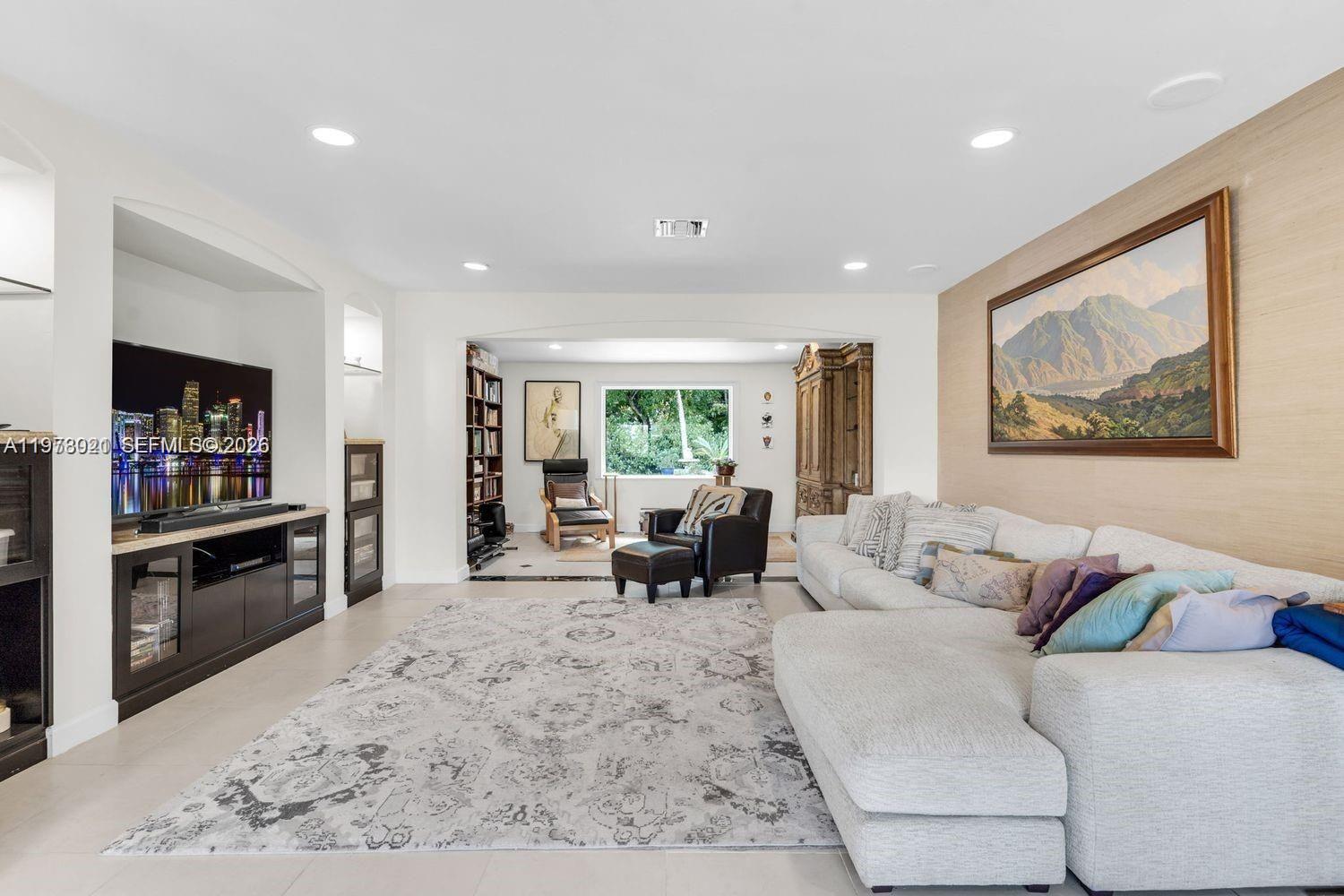 6440 Southwest 129th Terrace Pinecrest, FL 33156 - Photo 6 of 7 a living room with furniture and a flat screen tv