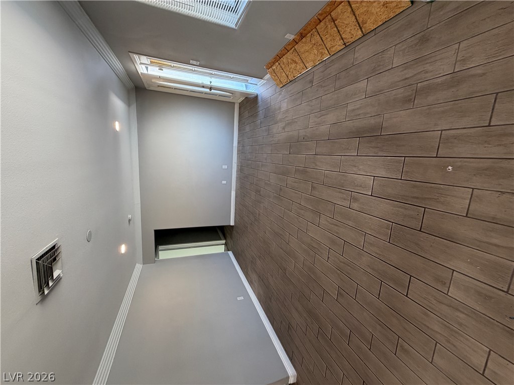 2820 South Sandhill Road, Unit A Las Vegas, NV 89121 - Photo 12 of 26 The striking wood-look accent wall creates a warm, inviting atmosphere in this versatile hallway space.