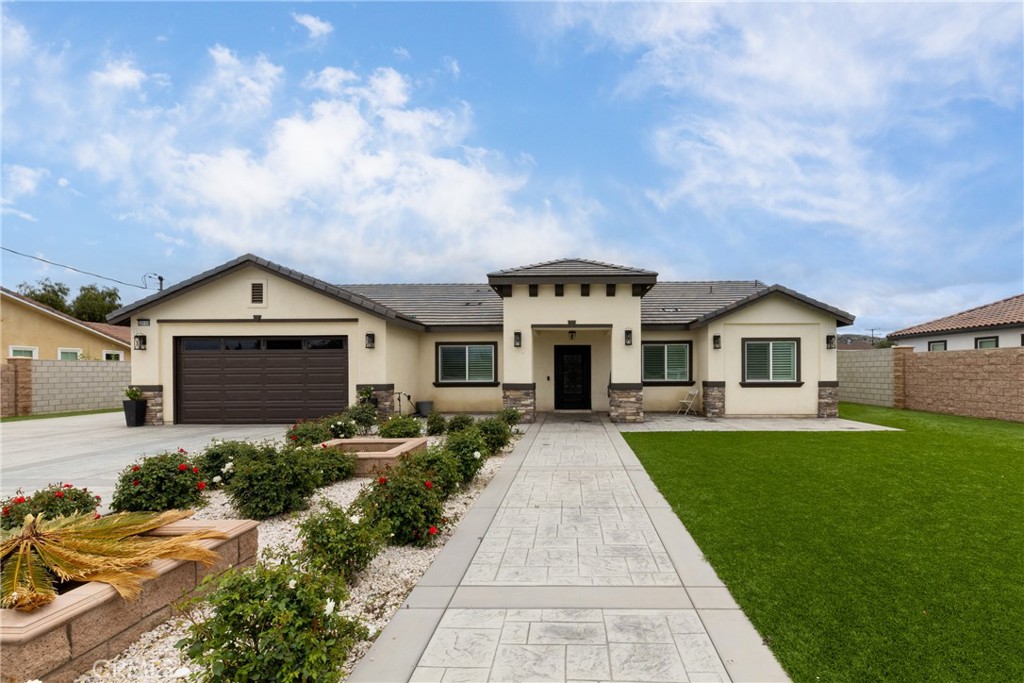 a front view of a house with a yard and garage