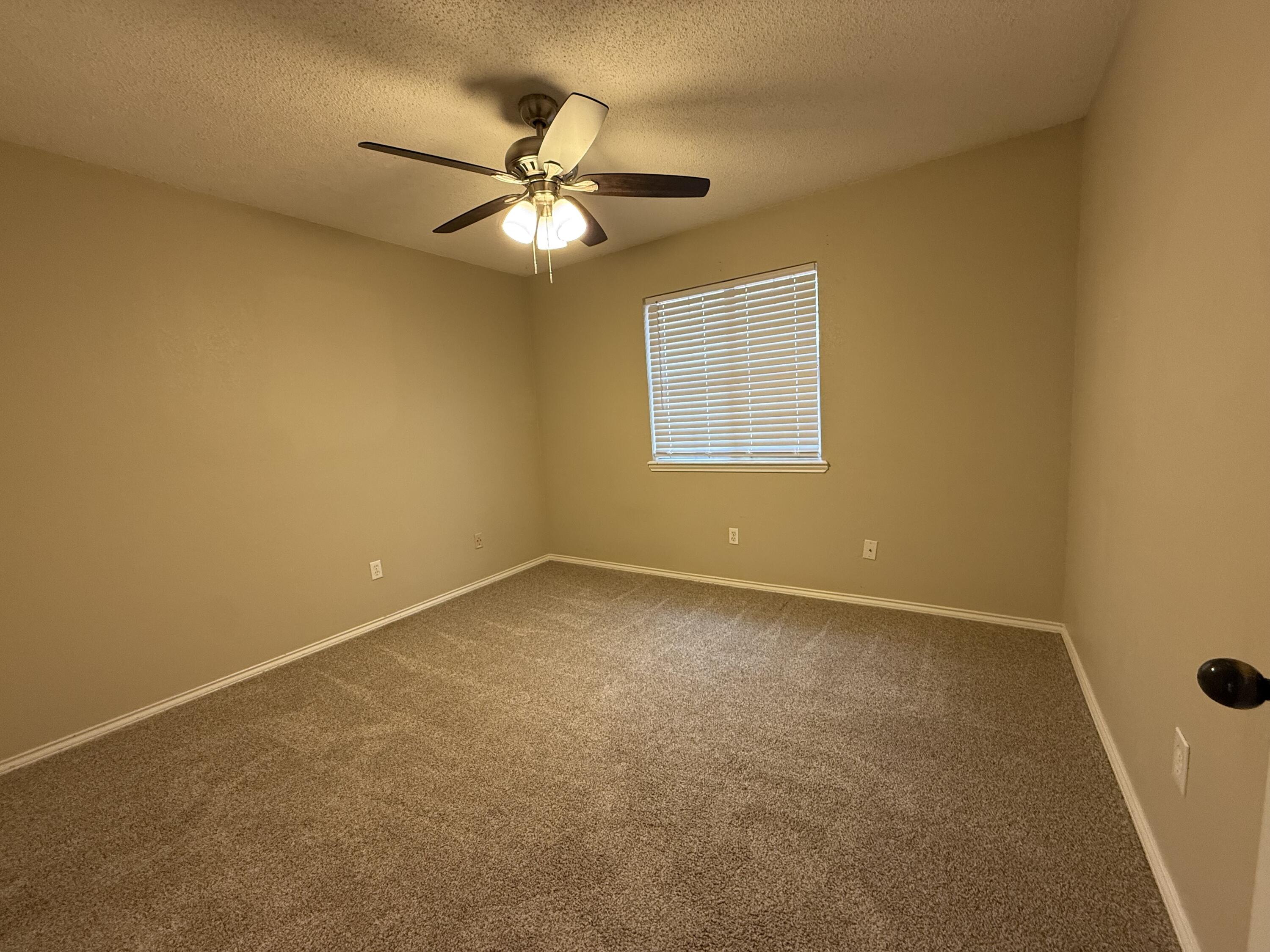 5705 87th Street Lubbock, TX 79424 - Photo 13 of 16 a view of an empty room with a window