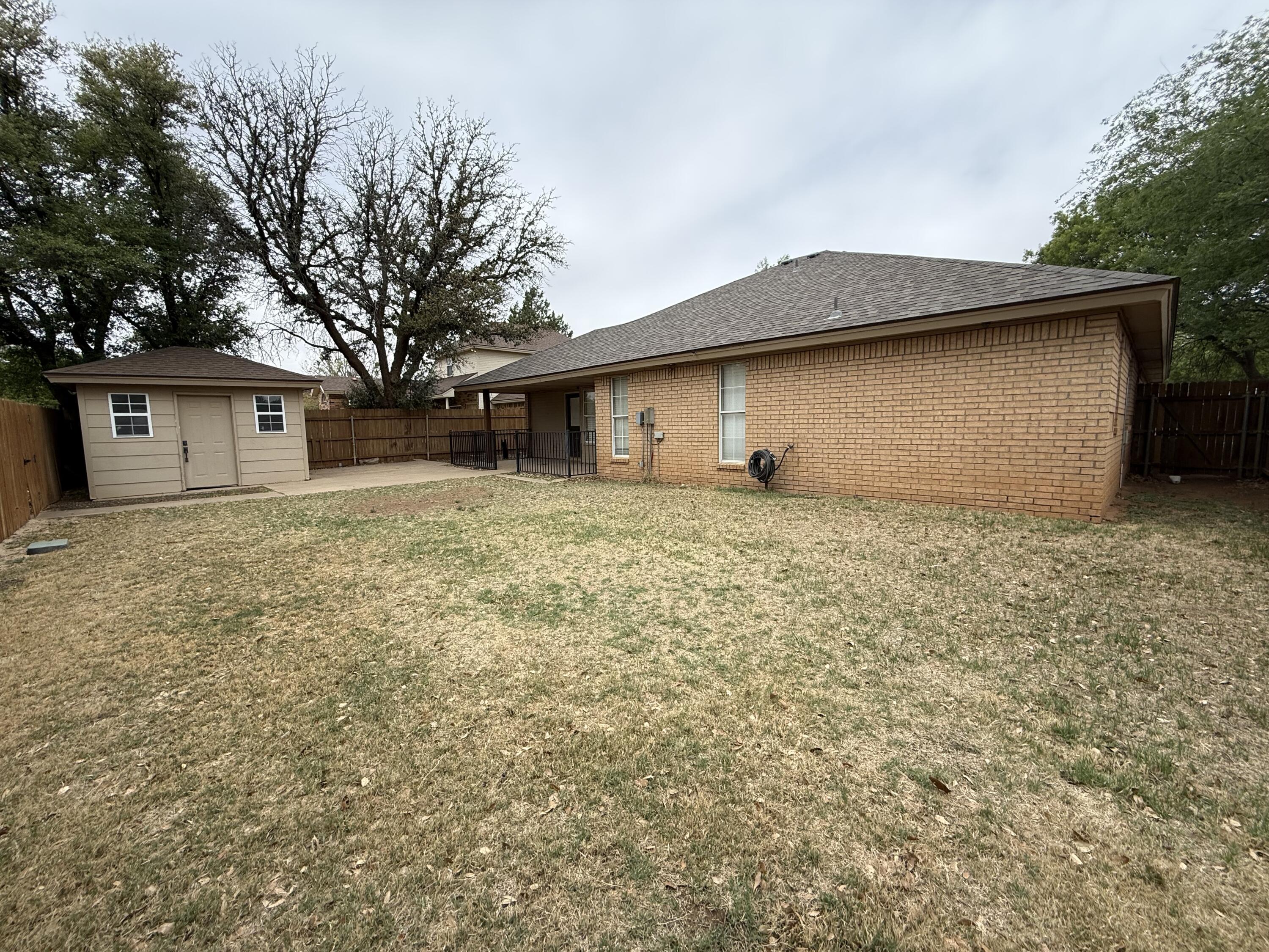 5705 87th Street Lubbock, TX 79424 - Photo 16 of 16 a house that has a tree in front of it