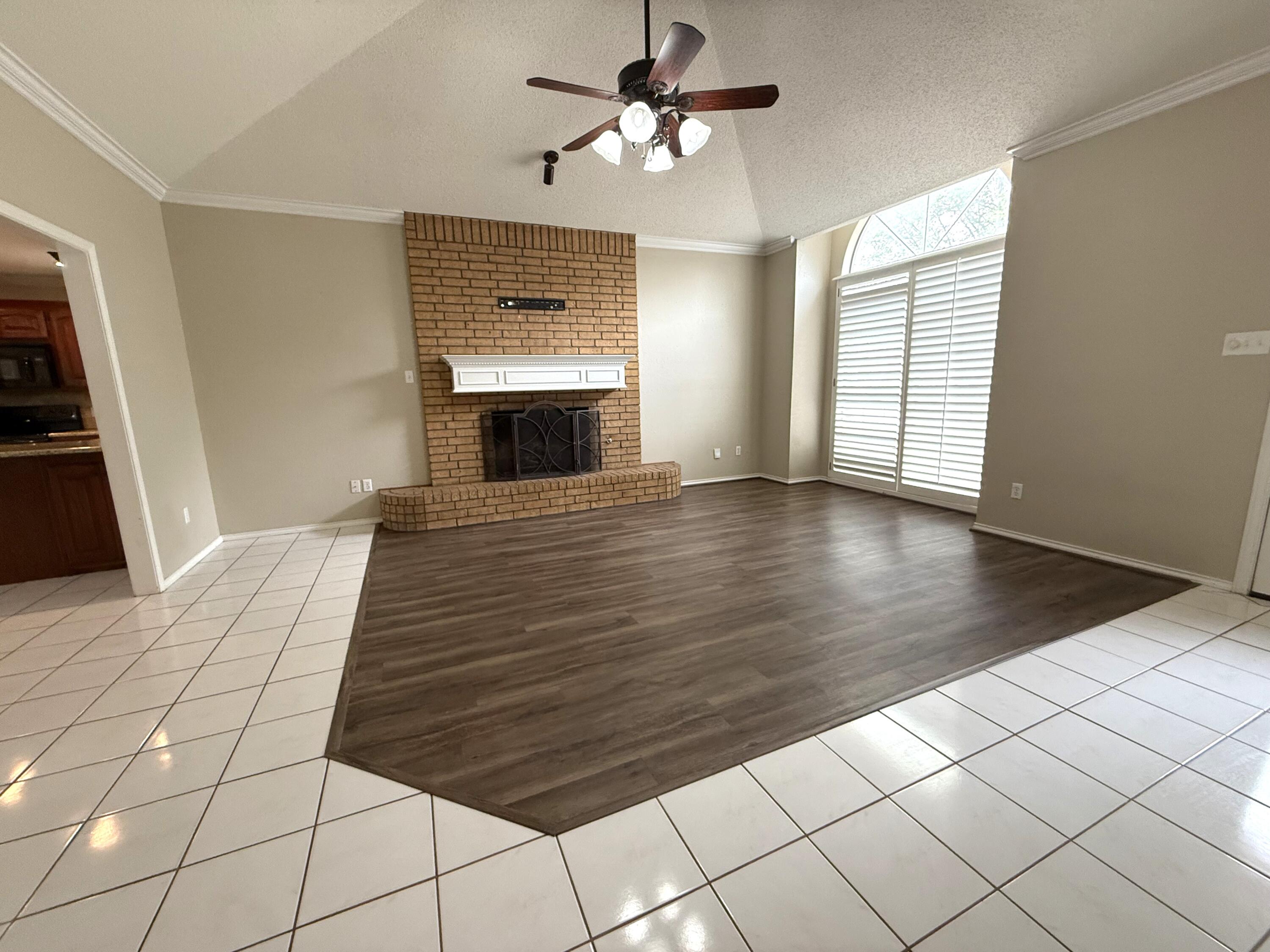 5705 87th Street Lubbock, TX 79424 - Photo 4 of 16 a view of empty room with wooden floor and fan