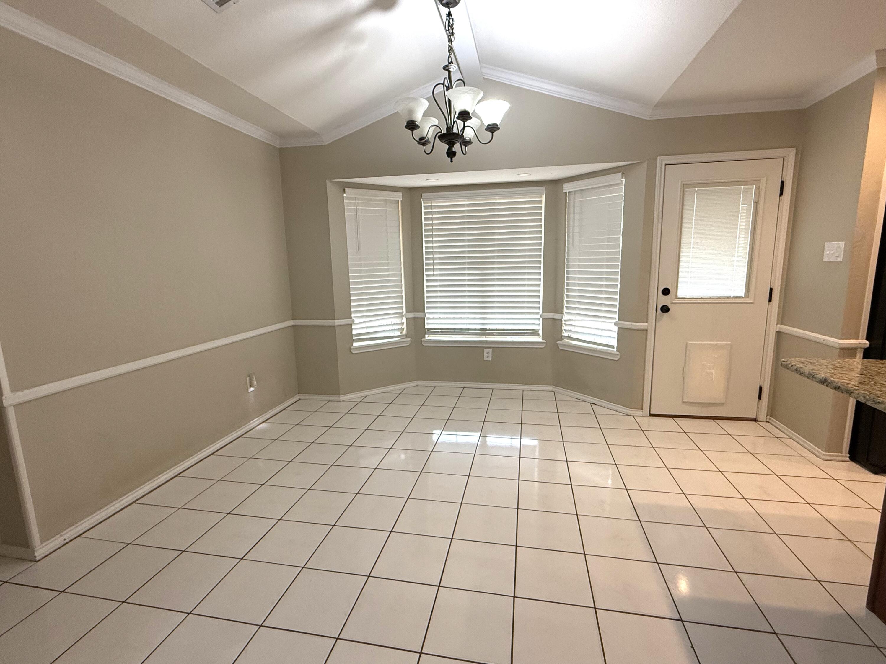 5705 87th Street Lubbock, TX 79424 - Photo 7 of 16 a view of an empty room and window