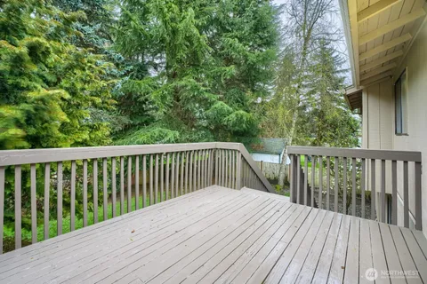 a balcony with wooden floor and fence