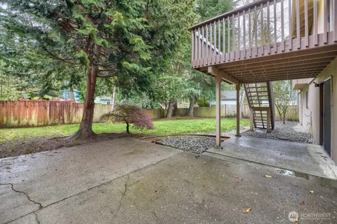 a view of backyard with barbeque grill and outdoor seating