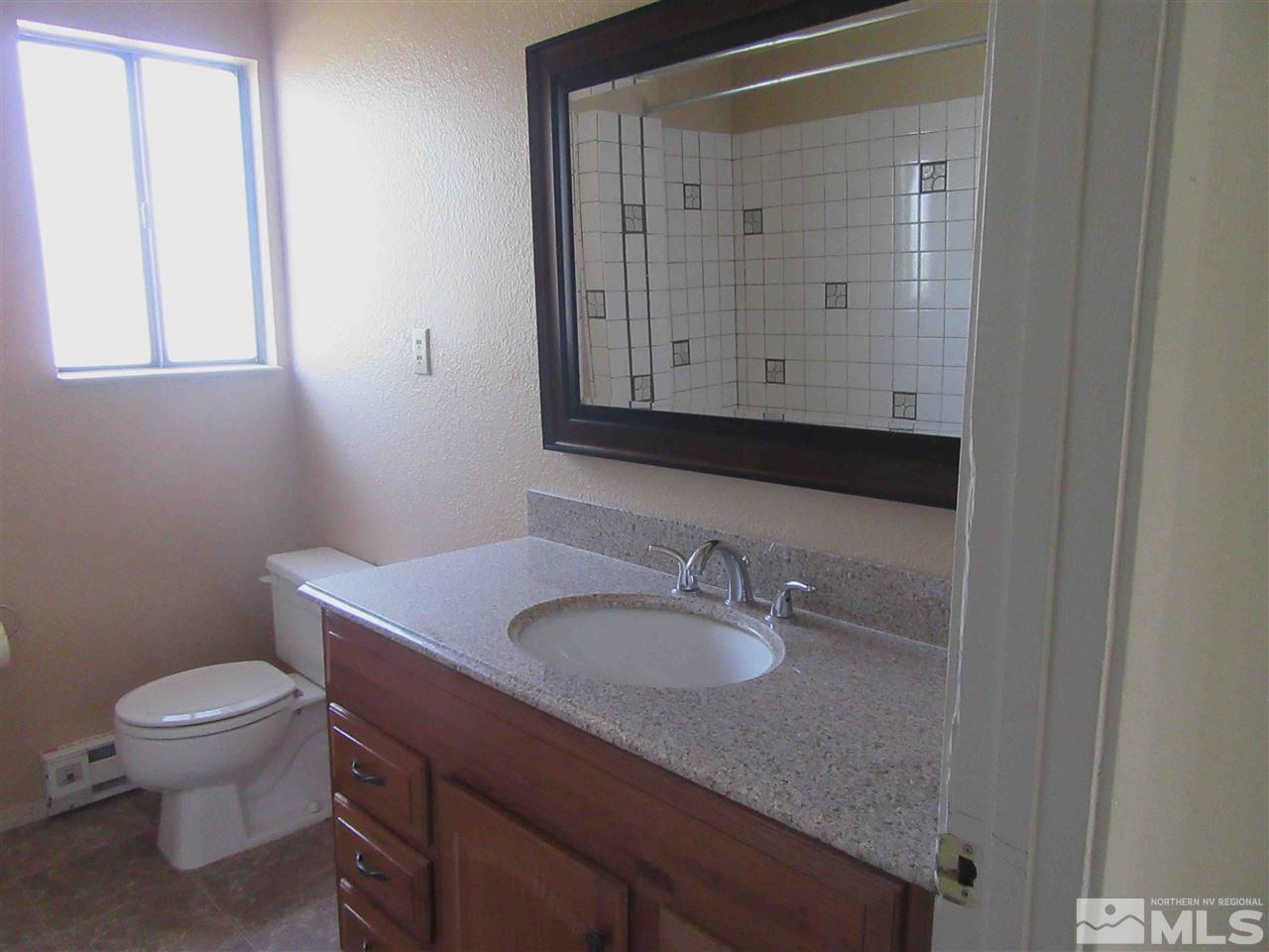 4800 Koenig Road Reno, NV 89506 - Photo 11 of 17 a bathroom with a sink a toilet and mirror