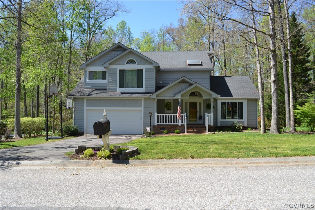 15012 Walnut Bend Road Midlothian, VA 23112 - Photo 1 of 27 a front view of a house with a yard and garage