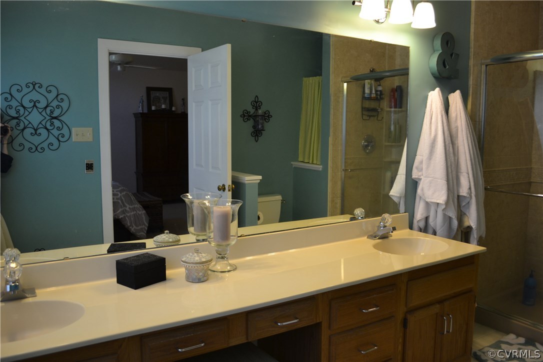 15012 Walnut Bend Road Midlothian, VA 23112 - Photo 14 of 27 a bathroom with a double vanity sink and a mirror