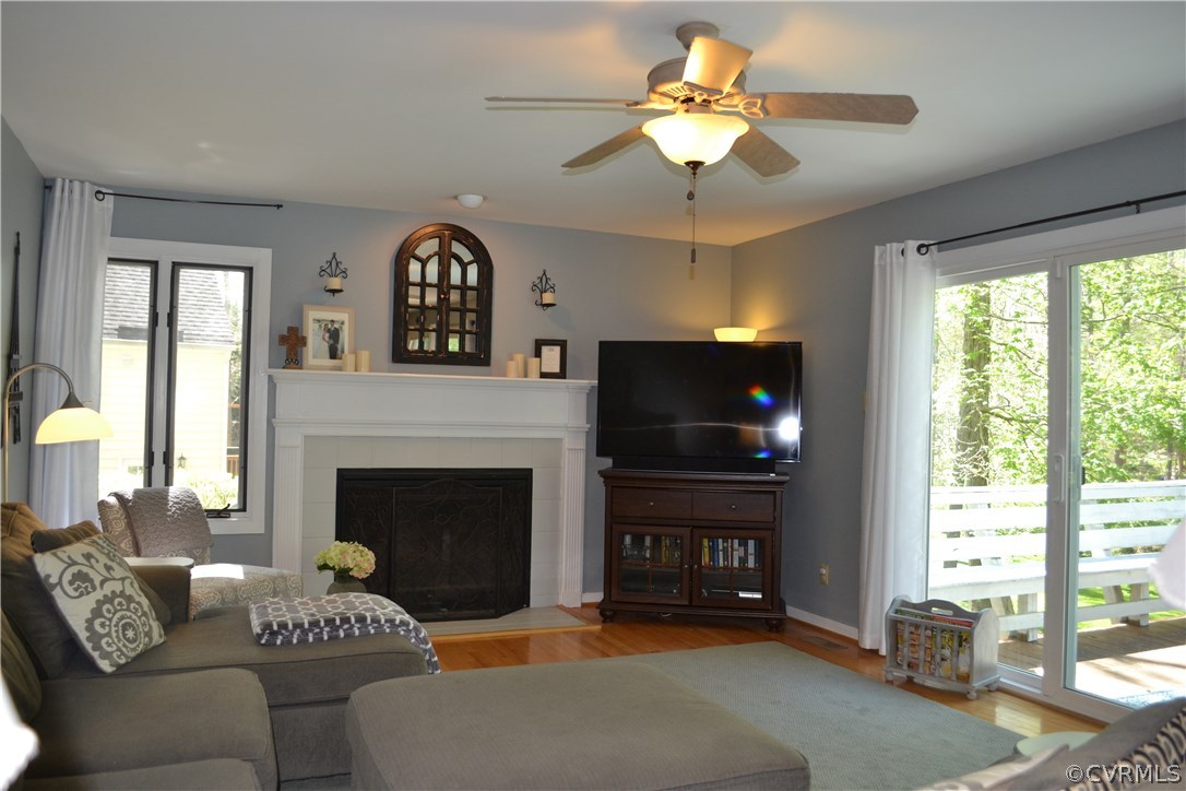 15012 Walnut Bend Road Midlothian, VA 23112 - Photo 7 of 27 a living room with furniture a fireplace and a flat screen tv